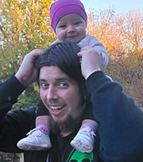 Bradley with an young baby on their shoulders