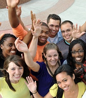 multi youth looking towards camera waving and smiling